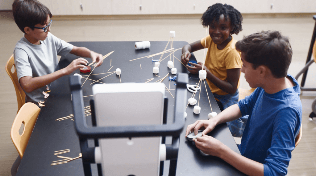 Image features students working on a teacher-guided group project through use of Swivl's Mirror, an automated reflective tool that supports student reflection and engagement.